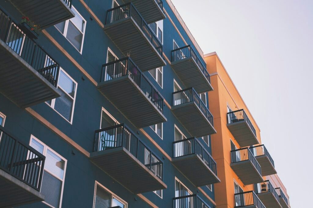 Low-angle view of a modern multi-story apartment building with balconies